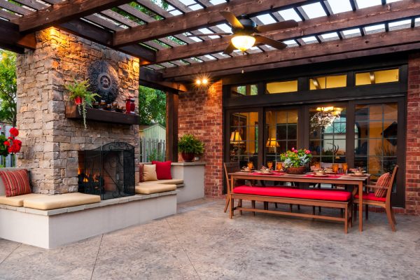 Captivating-Outdoor-Sitting-Space-with-Patio-Decorating-Ideas-Created-near-Stone-Fireplace